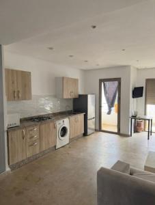 a kitchen with a washer and dryer in a room at 2BR Beach Apt, Pool, Luxury place in Mansouria