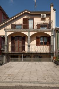 a large house with a balcony on top of it at Bnbook Olona-Fiera Milano in Pero