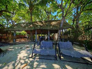 a group of chairs and a gazebo at Pacific View Point in Matnog