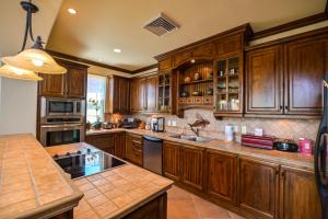 a large kitchen with wooden cabinets and a sink at Montebello 2C - 3 bdr 3 bath Ocean View in La Mona