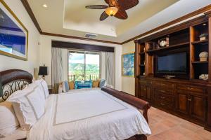 a bedroom with a bed and a flat screen tv at Montebello 2C - 3 bdr 3 bath Ocean View in La Mona