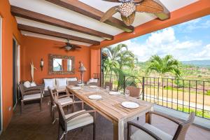 a dining room with a table and chairs and a balcony at Montebello 2C - 3 bdr 3 bath Ocean View in La Mona