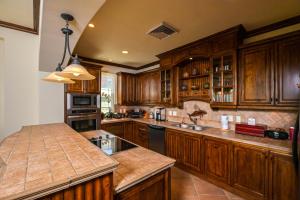 a kitchen with wooden cabinets and a counter top at Montebello 2C - 3 bdr 3 bath Ocean View in La Mona +31 photos