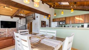 a kitchen and dining room with a wooden table and chairs at Saratoga Vista by AvantStay Waterfront Views in Langley +29 photos