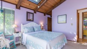 a purple bedroom with a bed and a chair at Saratoga Vista by AvantStay Waterfront Views in Langley