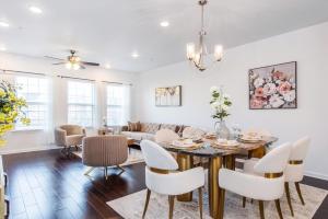 a dining room and living room with a table and chairs at Glam Family Funhouse NYC Access Adventure in Fair Lawn