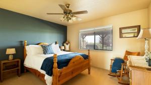 a bedroom with a bed and a ceiling fan at Olive Ranch by AvantStay Enjoy Sunsets over the Valley 4.5 Acre Ranch Home in Paso Robles