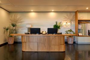 an office with a reception desk with two computers on it at Pinctada Hotel Broome in Broome +33 photos
