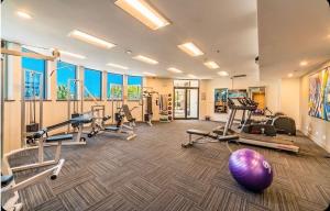 a gym with several treadmills and exercise machines at Stunning Oceanview - Beachfront hotel suite in Gold Coast