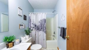 a bathroom with a shower and a toilet and a sink at The Nest at Brier Crest by AvantStay Game Room Expansive Deck Fire Pit in Blakeslee +42 photos