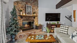 a living room with a christmas tree and a fireplace at Slopeside Escape by AvantStay Walk to Ski Lifts Arcade Games Shuffleboard in Tannersville