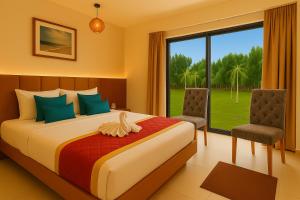 a bedroom with a bed and a large window at Road House Resort in Rāmeswaram +33 photos