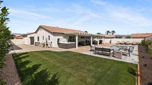 a backyard with a pool and a house at Montego by AvantStay Private Yard w Pool Hot Tub in Indio