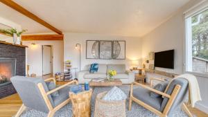 a living room with a couch and a tv at Four Bears by AvantStay Walk to Beach Hot Tub Ocean View in Arch Cape