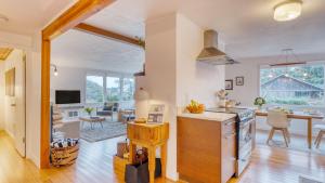 a kitchen and living room with a table and a counter top at Four Bears by AvantStay Walk to Beach Hot Tub Ocean View in Arch Cape
