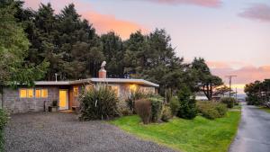 a small house with a statue on top of it at Four Bears by AvantStay Walk to Beach Hot Tub Ocean View in Arch Cape