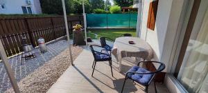 a patio with a table and chairs on a porch at unit_type_semidetached_house Siofok 54624 in Balatonszabadi Fürdőtelep