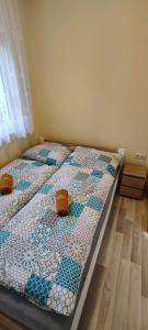 a bedroom with a bed with a quilt on it at unit_type_semidetached_house Siofok 54624 in Balatonszabadi Fürdőtelep