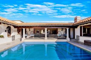 a swimming pool in front of a house at Casa Brooks in Cabo San Lucas