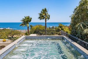 a swimming pool with the beach in the background at Casa Brooks in Cabo San Lucas