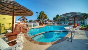 a pool with a water slide in a resort at Shared Resort-Style Pool Playground Patio w Bar Tidal Times by AvantStay in Port Aransas
