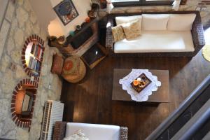 an overhead view of a living room with a couch and a table at Artemis Stone House in Psakoudia