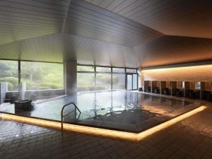a large swimming pool in a building at Grand Mercure Nasu Highlands Resort & Spa in Nasu