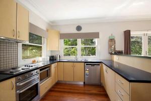 a kitchen with stainless steel appliances and wooden floors at The Nineteenth in Blackheath