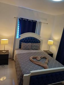a bedroom with a bed with a heart shapedigunigunigunigunigunigunigun at Rolando share apart in Punta Cana