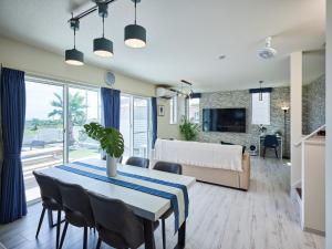 a dining room and living room with a table and chairs at VOGUE D, a private inn with a panoramic view - Vacation STAY 86199v in Isumi