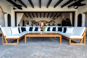 uma sala de estar com sofás brancos e uma mesa de centro em Casa Mar em El Tule