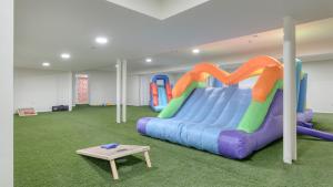 a play room with a large inflatable slide at Game Farm Villa by AvantStay 10BDR Private Pond Spa Pool Family-Friendly in Catskill