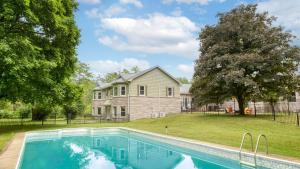 a swimming pool in front of a house at Game Farm Villa by AvantStay 10BDR Private Pond Spa Pool Family-Friendly in Catskill