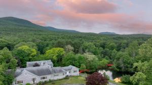 an aerial view of a house with a lake and mountains at Game Farm Villa by AvantStay 10BDR Private Pond Spa Pool Family-Friendly in Catskill