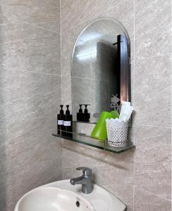 a bathroom with a sink and a mirror at Nam Đô Hotel Cần Thơ Downtown in Can Tho