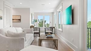 a living room with a couch and a table at All Decked Out Seagrove by AvantStay Priv PoolHot Tub Ocean Views in Santa Rosa Beach