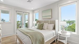 a white bedroom with a bed and two windows at All Decked Out Seagrove by AvantStay Priv PoolHot Tub Ocean Views in Santa Rosa Beach +46 photos