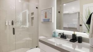 a white bathroom with a sink and a shower at Ski La Vie by AvantStay Hot Tub Game Room Near the Ski Slopes in Heber City +43 photos