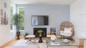 a living room with white walls and a fireplace at Stardust by AvantStay Views Hot Tub Pool Table in Malibu