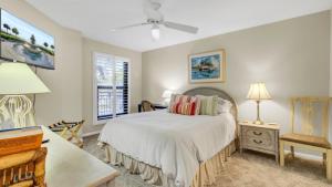 a bedroom with a bed and a desk and a window at 123D Shipwatch by AvantStay Beach Access Pool in Isle of Palms +31 photos