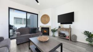 a living room with a couch and a fireplace at Oceanfront 2BR Rooftop Deck Beach Access Strand Way B in Oceano