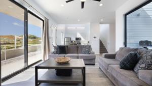 a living room with a couch and a table at Oceanfront 2BR Rooftop Deck Beach Access Strand Way B in Oceano