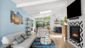 a living room with a couch and a fireplace at Stone Lagoon by AvantStay Steps to the Beach Backyard Oasis in San Clemente