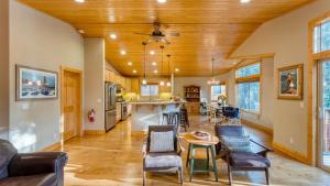 a living room with a table and chairs and a kitchen at Washoe Chalet by AvantStay Game Room Hot Tub Putting Green Fire Pit in Tahoma