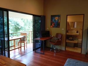 een kamer met een bureau met een computer en een balkon bij Butterfly Cottage Tracy Island Had Yao in Ko Pha Ngan +14 foto's
