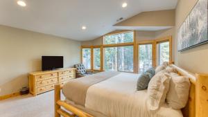 a bedroom with a large bed and a television at Washoe Chalet by AvantStay Game Room Hot Tub Putting Green Fire Pit in Tahoma