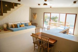 a kitchen and living room with a couch and a table at Villa Vento in Camocim