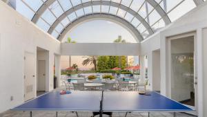 a ping pong table in a room with a glass ceiling at Encantamar Escape by AvantStay Prime Location Community Amenities in Dana Point