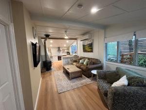 a living room with a couch and a table at Wild Platypus Stays in Eungella