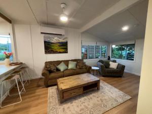 a living room with a couch and a coffee table at Wild Platypus Stays in Eungella